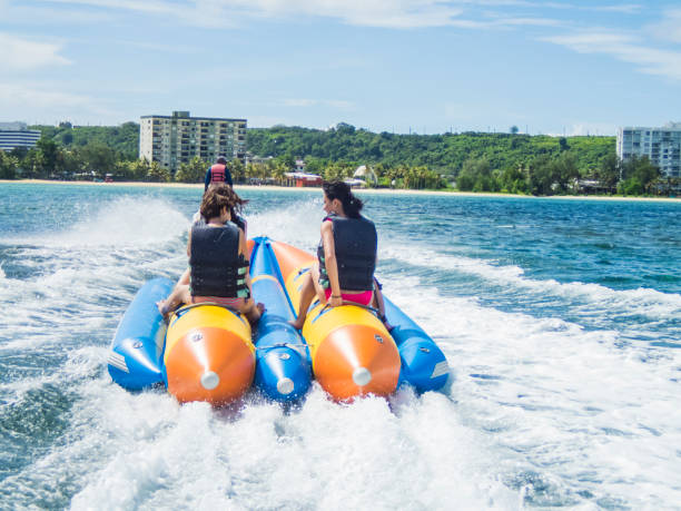 istock Three women riding a banana boat in guam 838095678