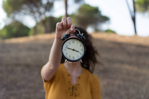istock Woman holding an alarm clock 838096036