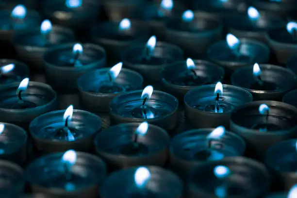 Nightlight. Lighted tea light candles at night with a silver blue tone. Cool mood lighting.
