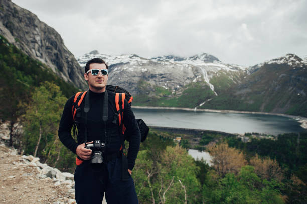 istock photographer or traveller using a professional DSLR camera in the nature for background 838102250
