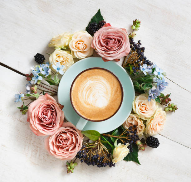 istock Cappuccino coffee and flowers composition on white wood 838103172