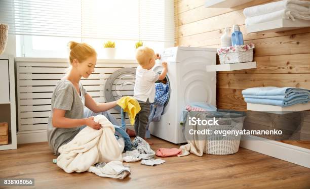 Happy Family Mother Housewife And Children In Laundry Load Washing Machine Stock Photo - Download Image Now