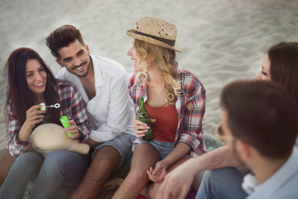 istock Group of cheerful friends having great time at beach 838108456