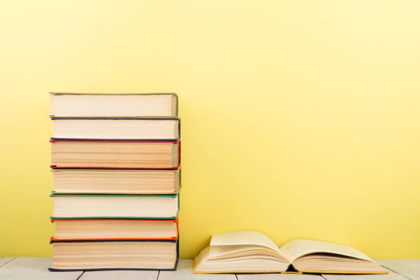 istock education and wisdom concept - open book on wooden table, color background 838115062