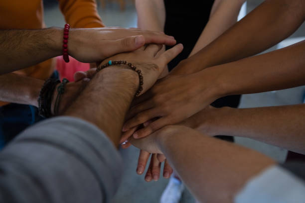 istock Close up of friends stacking hands 838115436