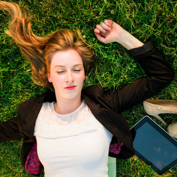 istock young independent woman relaxing on grass in park 838117864