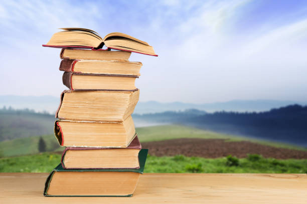 istock stack of books over the natural background 838118246