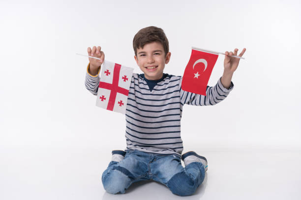 istock Little child with turkish and georgian flag 838118636