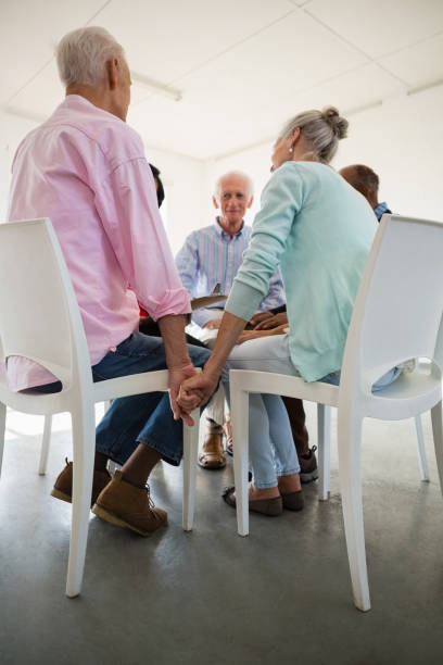 istock Low angle view of senior friends holding hands 838119902