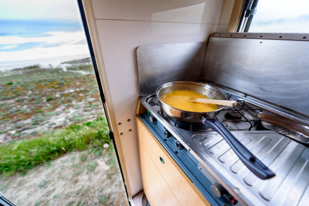istock Cooking dinner or breakfast in camper motorhome with beach view. 838127418