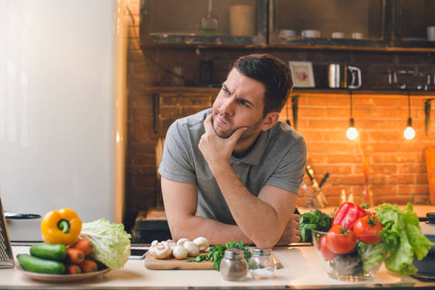 Young Man Vegan Healthy Food Meal Preparation stock photo