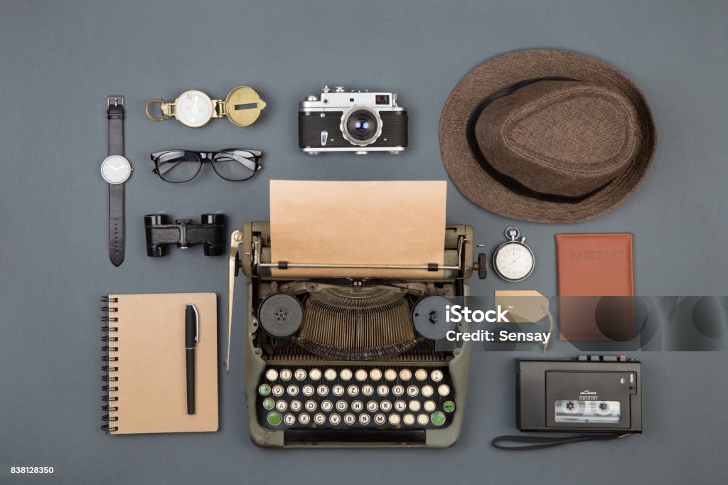 Journalist or private detective workplace - typewriter, camera, hat, recorder and other stuff Journalist or private detective workplace - typewriter, camera, hat, recorder and other stuff, flat view above Detective Stock Photo