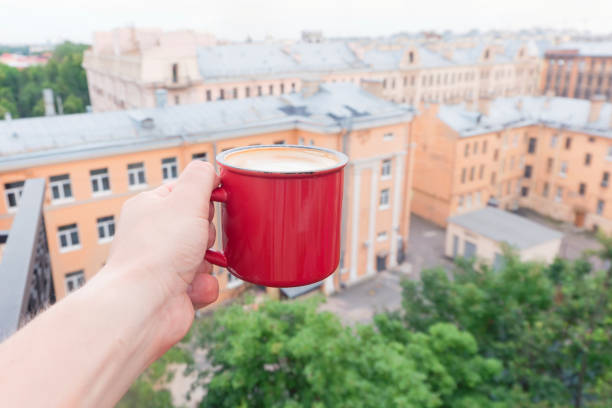 istock Man holding coffee red mug outdoors 838138964