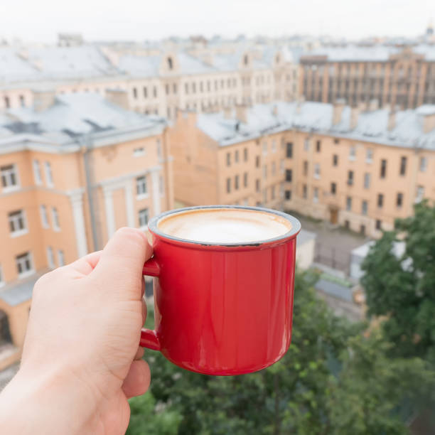 istock Man drinking coffee on balcony with roof top view. POV 838142892
