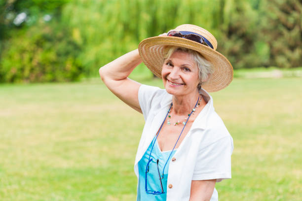 istock best ager women posing outdoors with hat 838143878