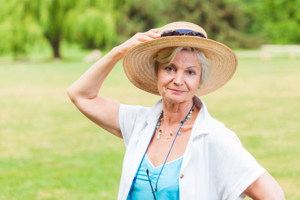 istock best ager women posing outdoors with hat 838143940