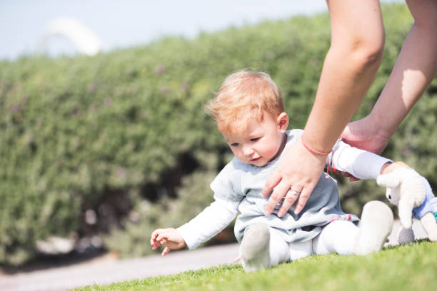 istock Lowering the baby in the park 838148228