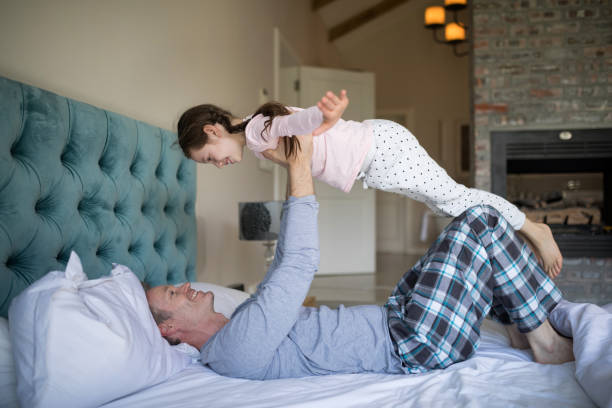 istock Happy father and daughter having fun on bed in bedroom 838158694