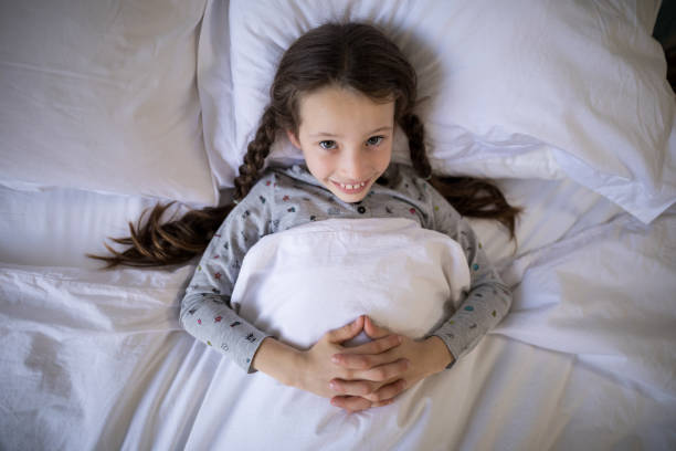 istock Smiling girl lying on bed in bedroom 838159818