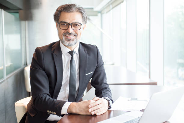 istock Smiling Business Leader Sitting at Office Desk 838164522