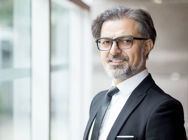 istock Smiling Middle-aged Business Leader at Window 838164578