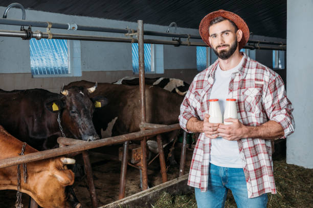 istock farmer with fresh milk in stall 838174026