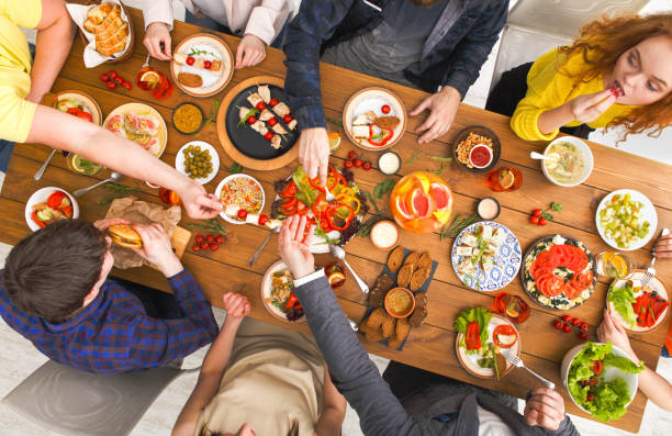 istock People eat healthy meals at served table dinner party 838180344