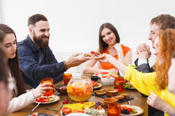 istock Group of happy people at festive table dinner party 838180650
