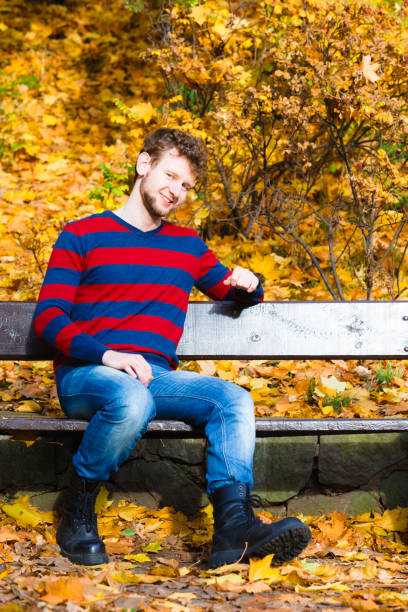 istock man sitting on the bench in park 838184690