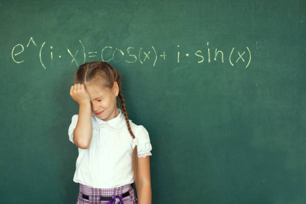 istock Child girl schoolgirl and compound formula on the chalkboard. Complex school program does not match the age of the child 838185236