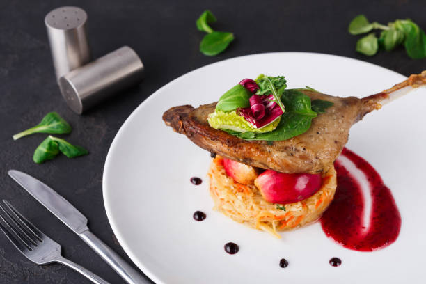 istock Restaurant meals. Duck confit with vegetables on black background 838197912