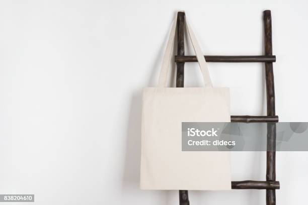 Fabric Cloth Shopping Bag Mockup Hanging On Vintage Wooden Stepladder Stock Photo - Download Image Now