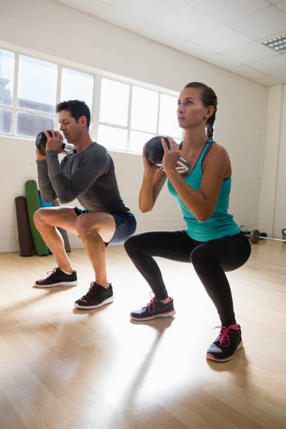 istock Full length of athletes exercising with kettlebells 838204768