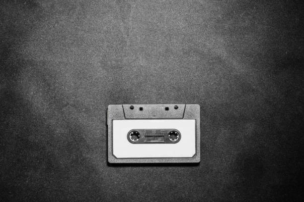 close up of retro vintage audio cassette tape on black background with copy space