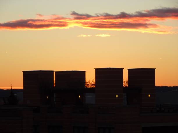 istock orange sunset over building rooftops in a city 838205520