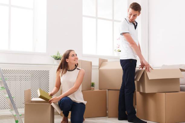 istock Young happy couple unpacking moving boxes 838212734