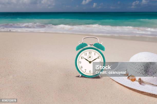Summertime Concept Alarm In The Tropical Beach Stock Photo - Download Image Now - Beach, Checking the Time, Daylight Saving Time