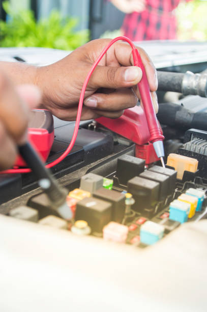 istock Auto mechanic uses a multimeter voltmeter to check the voltage level in a car battery. 838217878