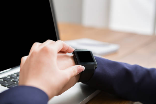 istock Close-up of woman using smart watch at workplace 838222634