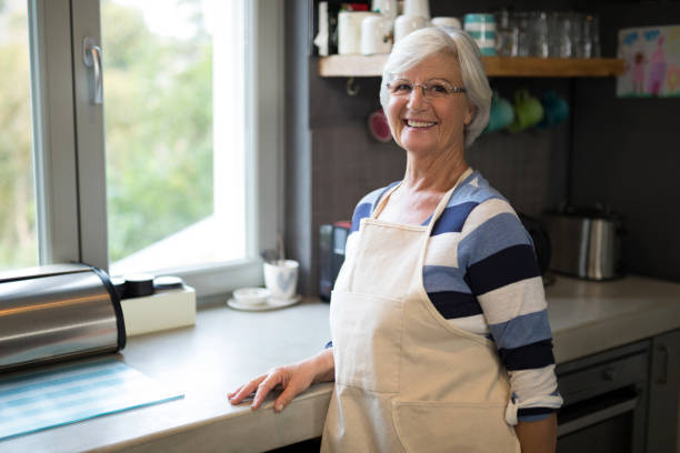 istock Senior woman standing near the kitchen counter 838223452