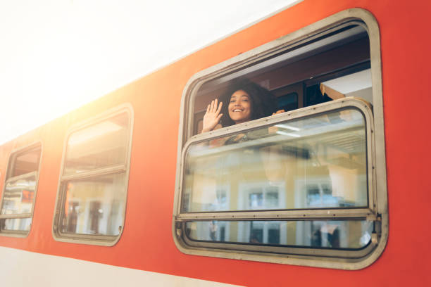 istock Woman waving hand through train window 838234490