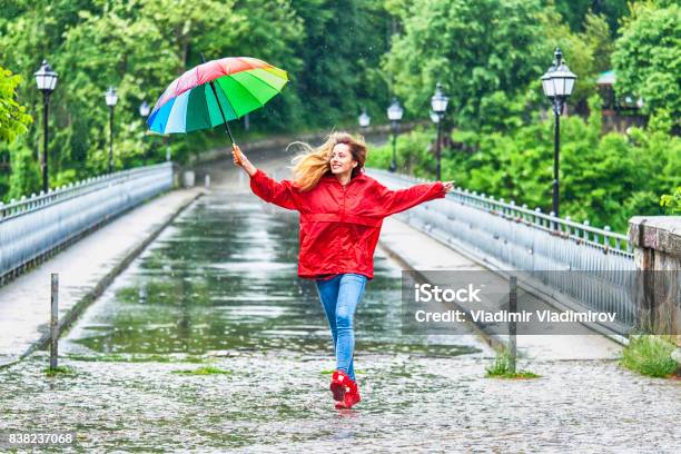 Beautiful Girl With Umbrella Dancing In The Rain Stock Photo - Download Image Now - Rain, Dancing, Women