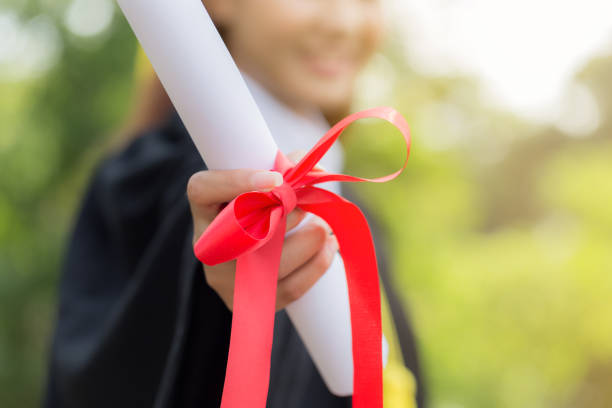 istock Graduate celebrating with certificate in her hand and looking 838237208