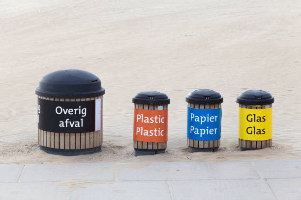 Black, red, blue and yellow recycle bins in a row, with copy space