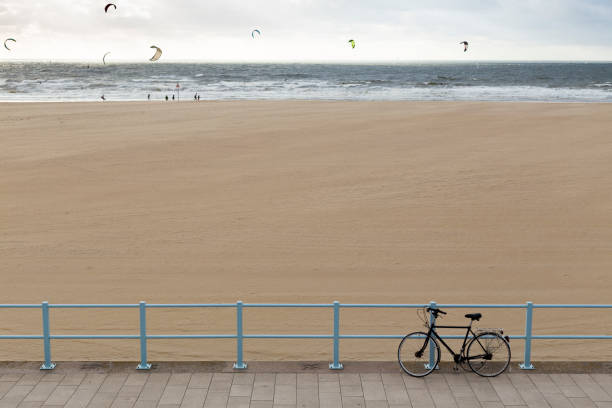 istock Bicycle in front and kiteboarders in the sea on background 838237490