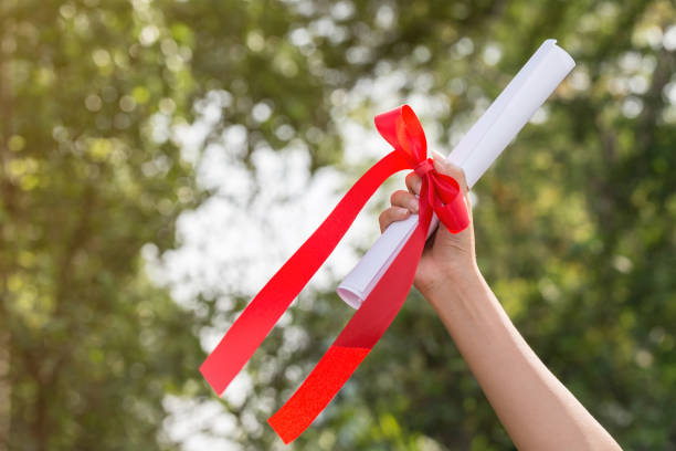 istock Graduate put her hands up and celebrating with certificate in her hand and feeling so happiness in Commencement day 838237804