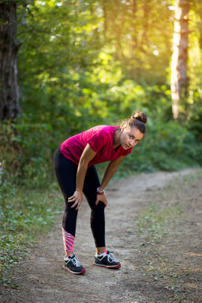istock Female athlete resting in the forest after the workout 838237878
