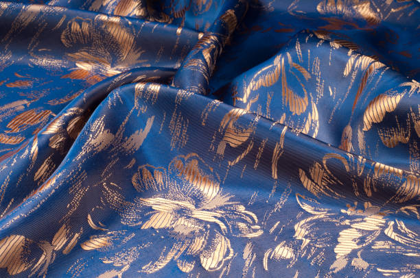 istock Fabric texture of silk with gold-painted flowers 838238102