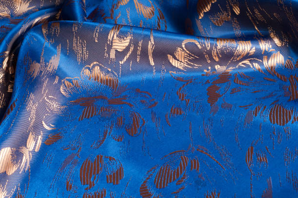 istock Fabric texture of silk with gold-painted flowers 838238500