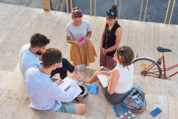 istock Group of students debating ideas and taking notes outdoor 838241838